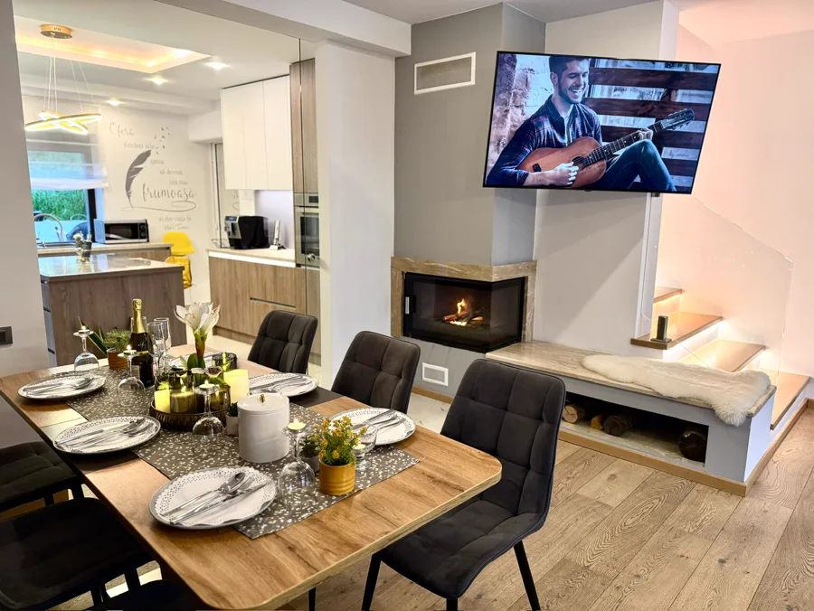 Dining area with fireplace, TV and view towards the kitchen